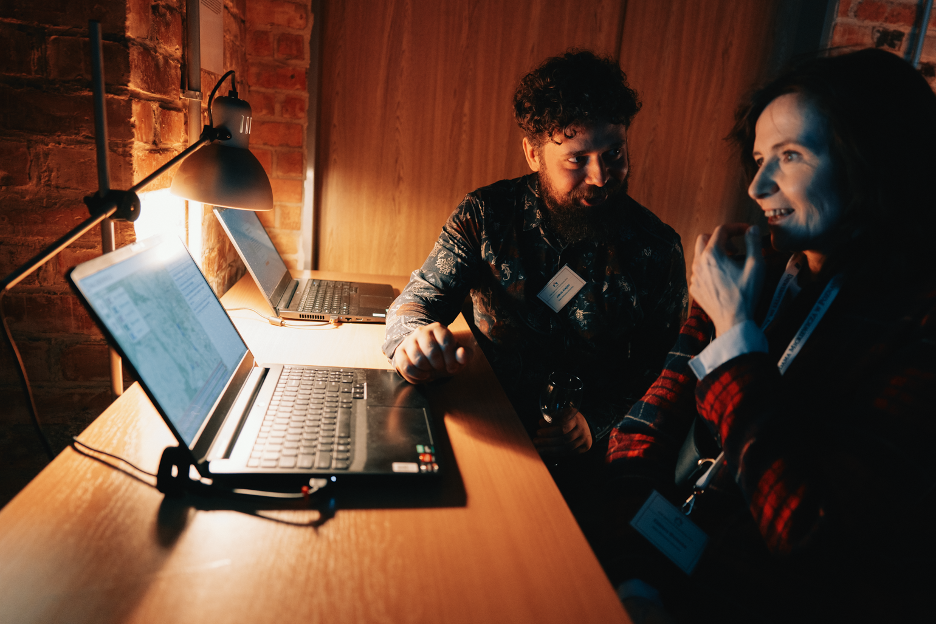 Sat with laptops open in dialogue with an author during the of electronic literature exhibition