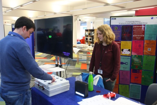 A visitor tries the Knowledge Makers' Memory Game
